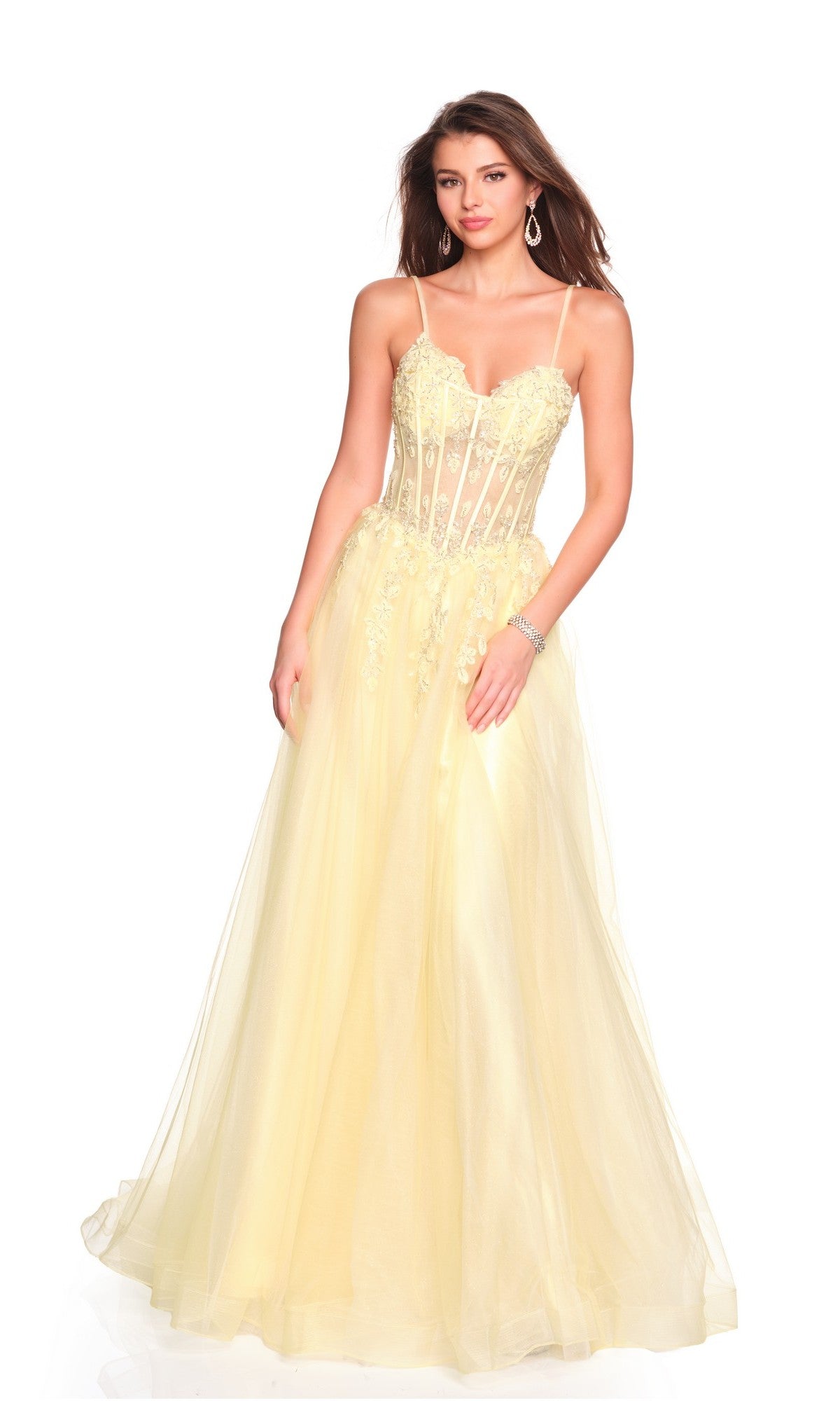 A woman in the Dave and Johnny 12424 long prom dress, featuring a light yellow color, fitted lace-embellished corset bodice, and elegant A-line skirt, stands against a white background.